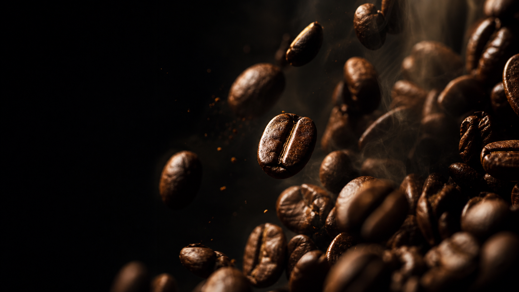 Roasted coffee beans suspended in warm light